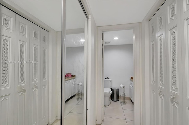 corridor featuring light tile patterned floors