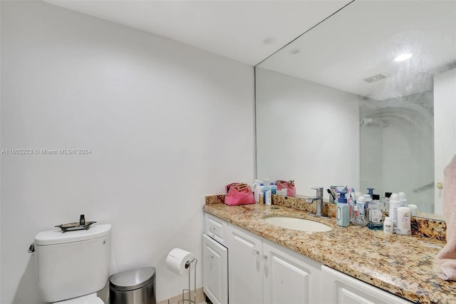 bathroom featuring toilet and vanity