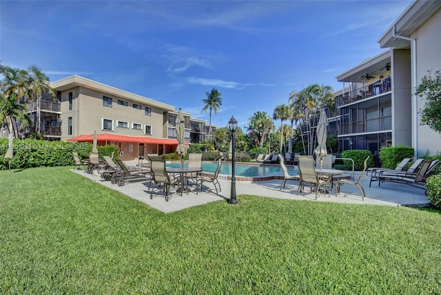 view of swimming pool with a lawn and a patio