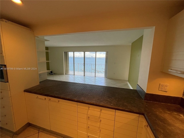 kitchen with light tile patterned flooring and cream cabinets