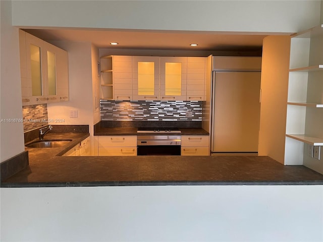 kitchen with sink, paneled built in refrigerator, black gas cooktop, wall oven, and decorative backsplash