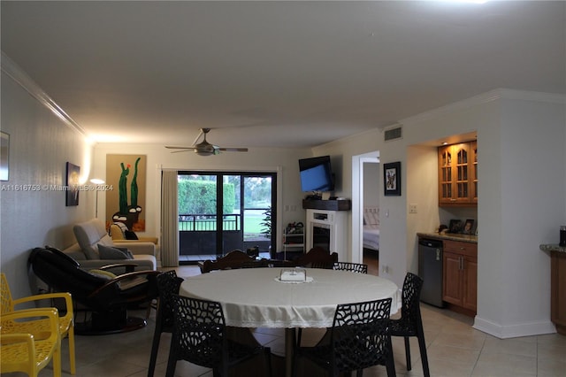 dining space featuring light tile patterned floors, ceiling fan, and crown molding