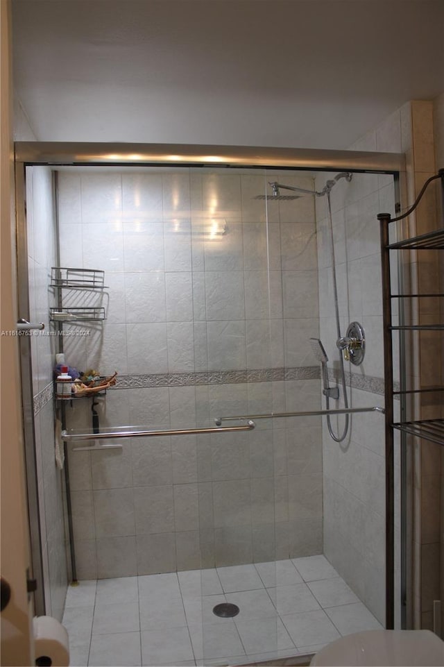 bathroom featuring a shower with shower door