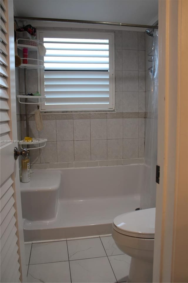 bathroom featuring tile patterned floors and toilet