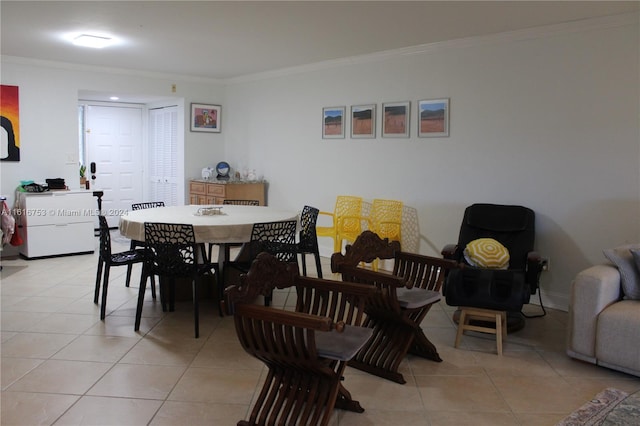 tiled dining room featuring crown molding