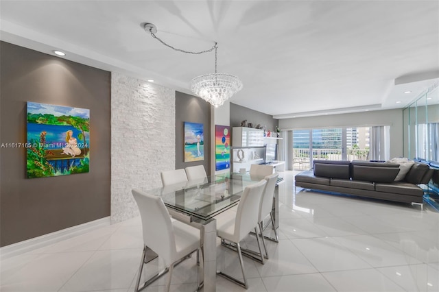 tiled dining area featuring a notable chandelier