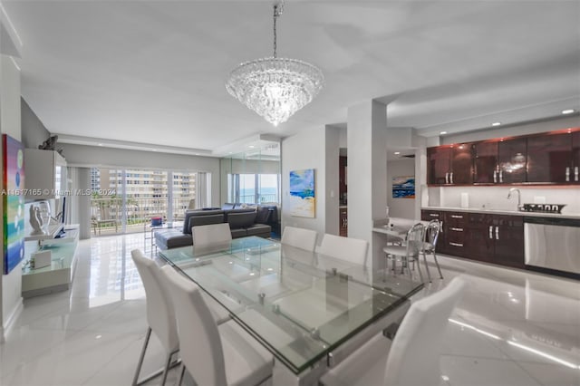 tiled dining area featuring sink and a notable chandelier