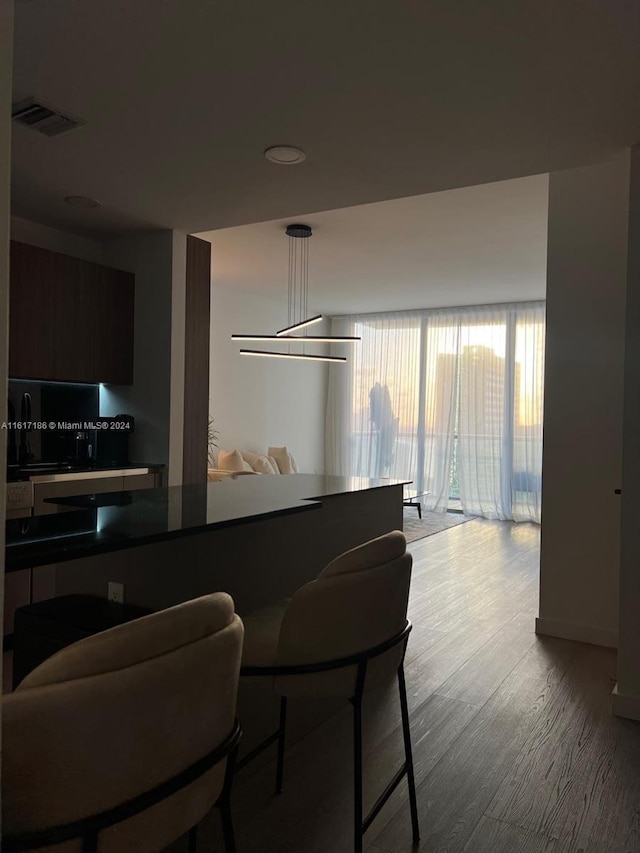 kitchen featuring dark brown cabinets and hardwood / wood-style floors