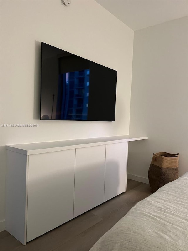 bedroom with dark hardwood / wood-style flooring