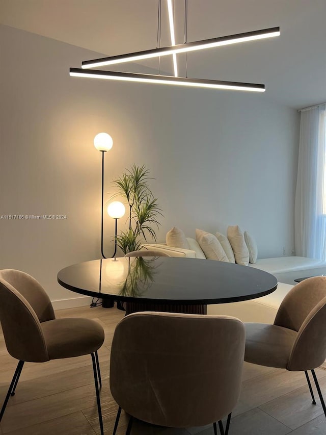 dining space with wood-type flooring