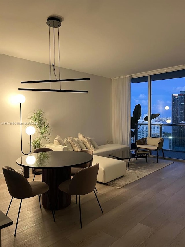 dining room with floor to ceiling windows and wood-type flooring