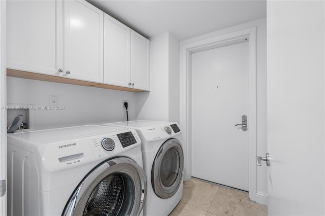 clothes washing area featuring cabinets, separate washer and dryer, and light tile patterned floors