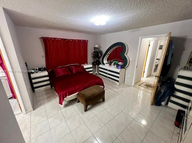 bedroom with light tile patterned floors and a textured ceiling