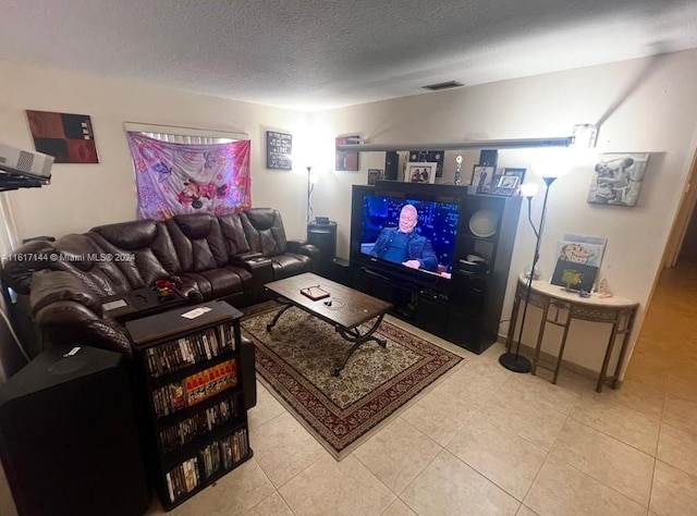 living room featuring light tile patterned flooring and a textured ceiling