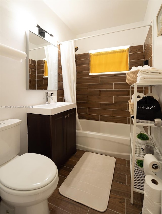 full bathroom featuring vanity, shower / tub combo, and toilet