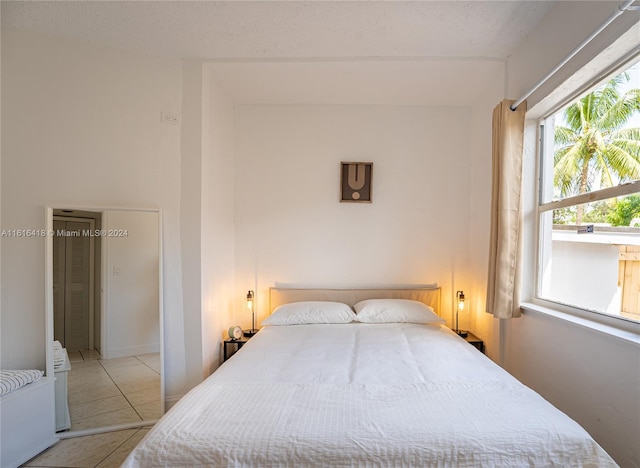 tiled bedroom with a textured ceiling