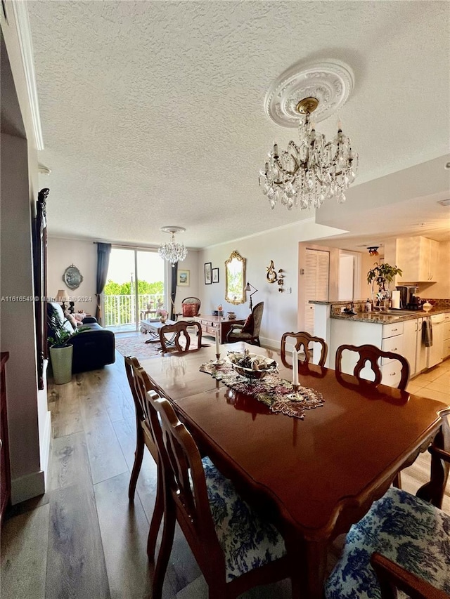 dining room featuring hardwood / wood-style flooring and a textured ceiling