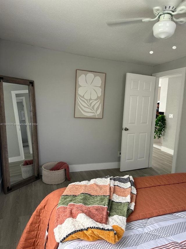 bedroom featuring hardwood / wood-style floors, a textured ceiling, and ceiling fan