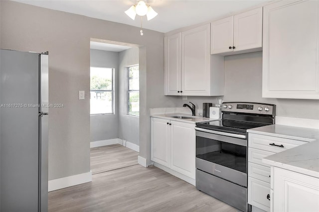 kitchen featuring white cabinetry, light hardwood / wood-style flooring, stainless steel appliances, and sink