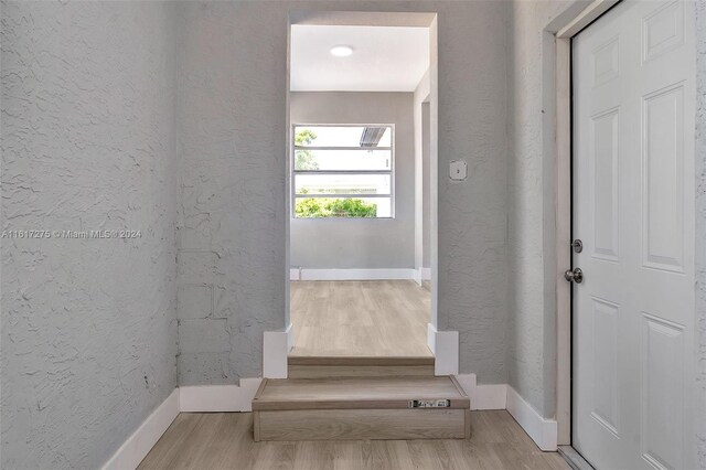 staircase with hardwood / wood-style flooring