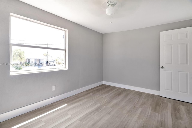 empty room with light wood-type flooring and ceiling fan