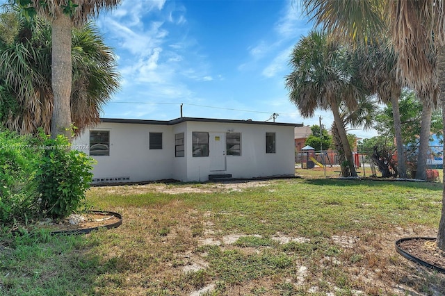 rear view of house with a lawn