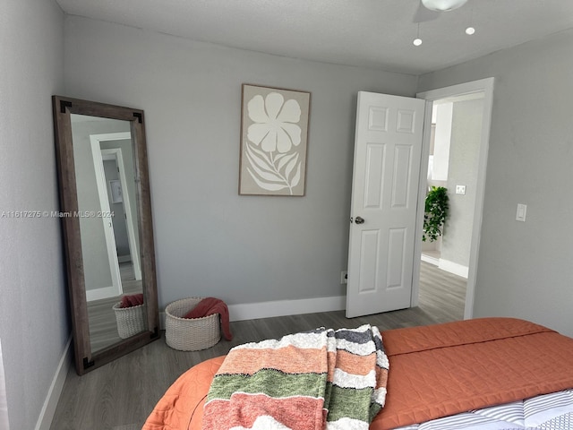 bedroom with ceiling fan and dark wood-type flooring