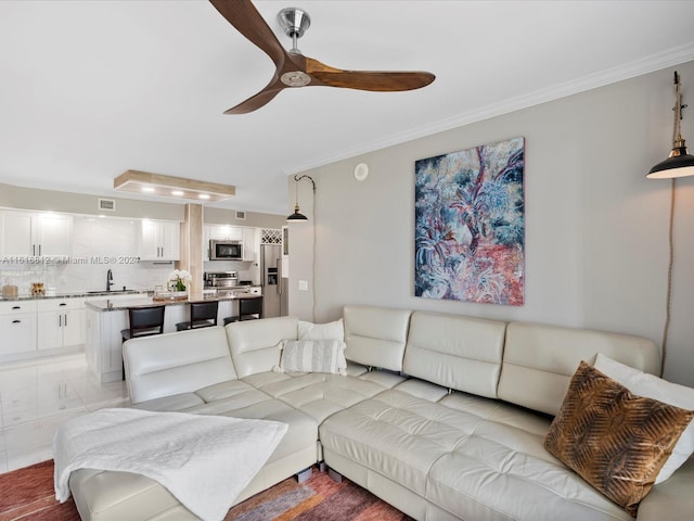 living room with ceiling fan and sink