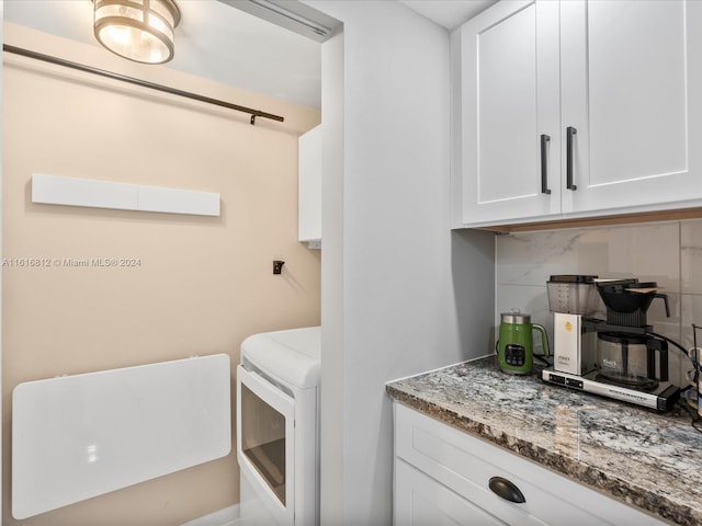 clothes washing area featuring washer / dryer