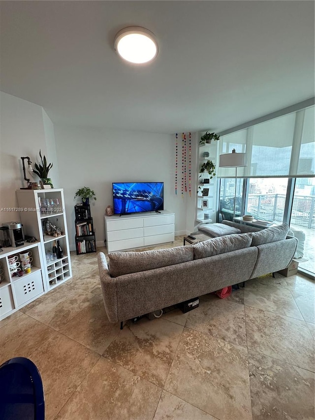 tiled living room featuring floor to ceiling windows