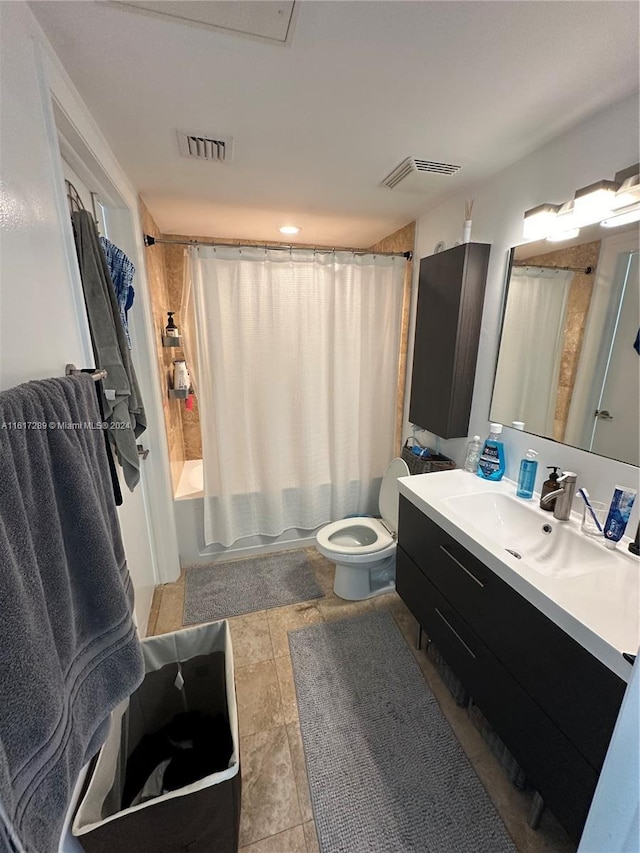 bathroom featuring shower / bath combination with curtain, visible vents, vanity, and toilet