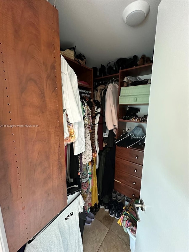 walk in closet with tile patterned floors