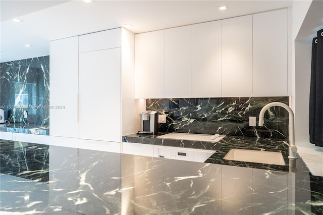 kitchen with sink, white cabinetry, and tasteful backsplash