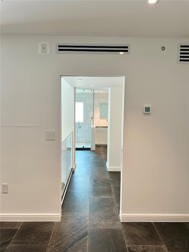 corridor with dark tile patterned floors