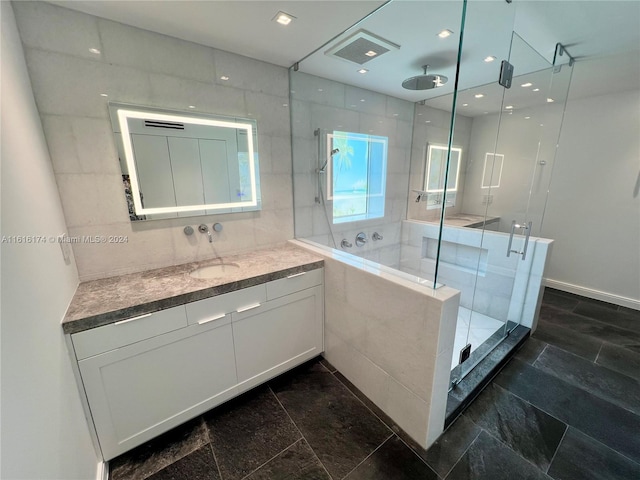 bathroom with tile walls, tile patterned floors, and vanity