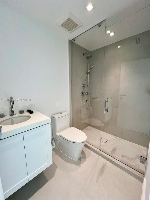 bathroom with vanity, toilet, and an enclosed shower