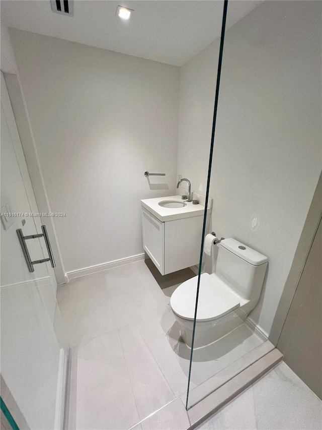 bathroom with tile patterned flooring, toilet, and sink