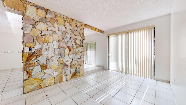 interior space with tile patterned flooring and a textured ceiling