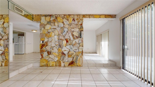 interior space featuring tile patterned floors and a textured ceiling