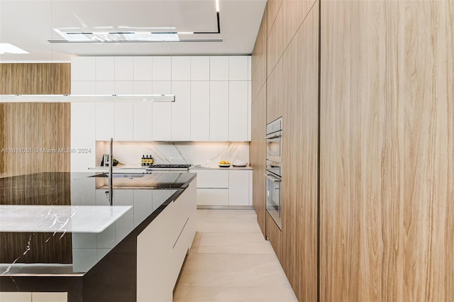 kitchen featuring dark stone countertops, sink, stainless steel appliances, and white cabinets