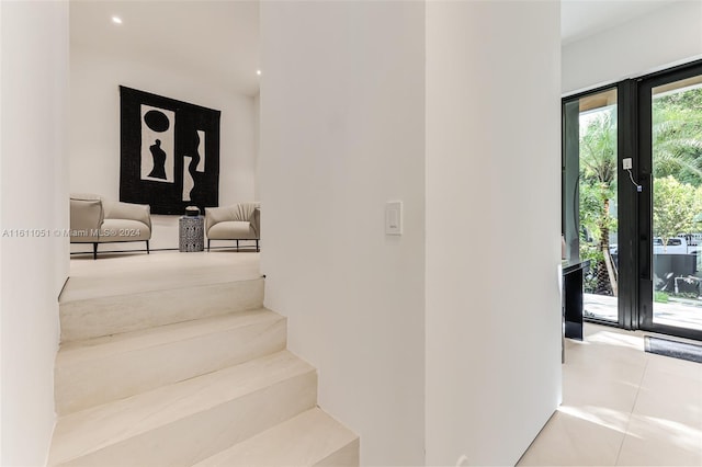 stairway with tile patterned floors