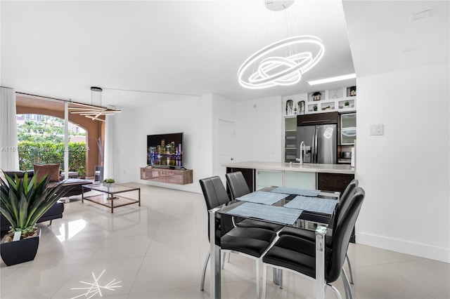 dining area featuring light tile patterned floors and a notable chandelier