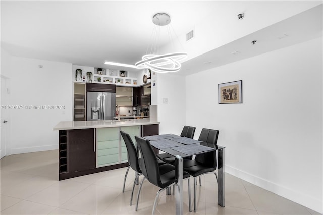 dining room with an inviting chandelier and light tile patterned floors