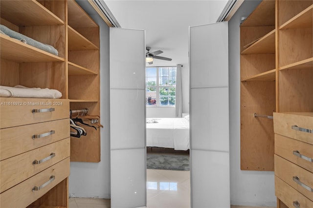 spacious closet featuring light tile patterned floors and ceiling fan