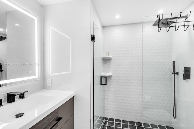 bathroom featuring vanity and tiled shower