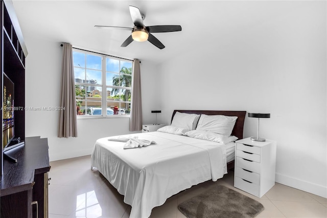 bedroom featuring light tile patterned floors and ceiling fan