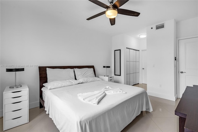 tiled bedroom featuring ceiling fan