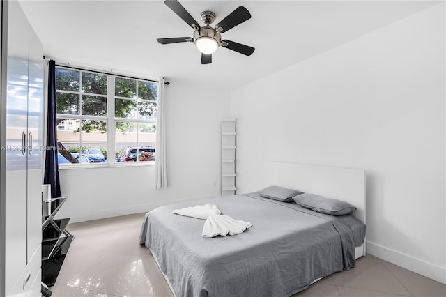 tiled bedroom with ceiling fan