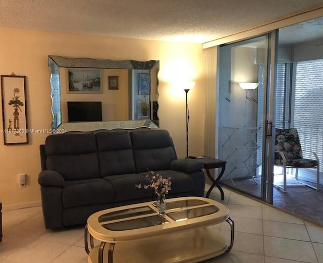 living room with a textured ceiling and tile patterned floors