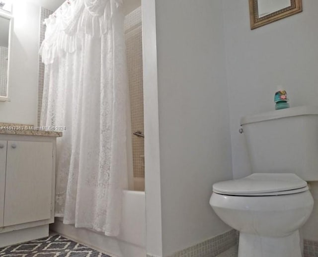 bathroom featuring vanity, tile patterned flooring, and toilet